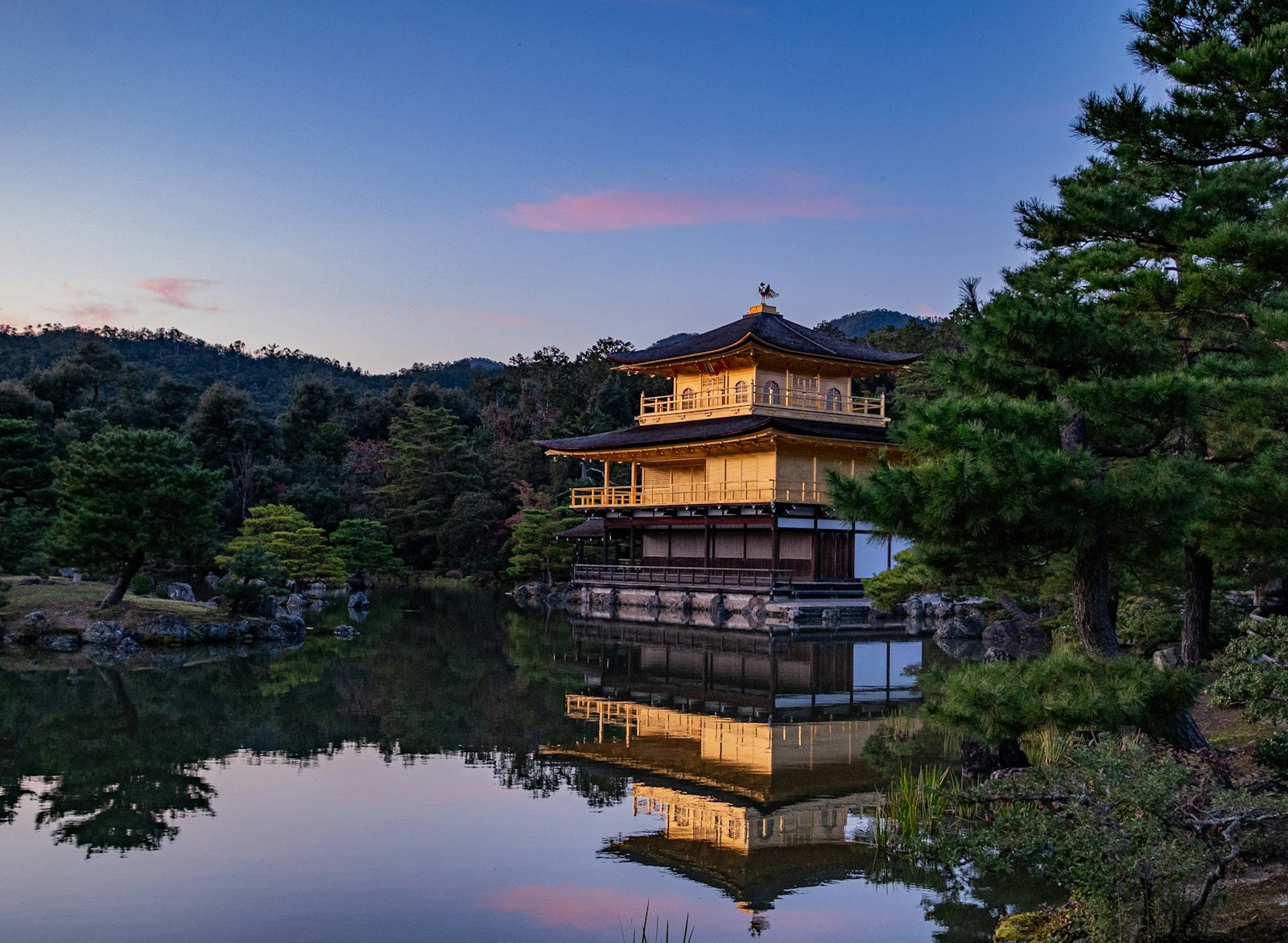 Kinkaku-ji Golden Pavilion reflected in its pond at dusk